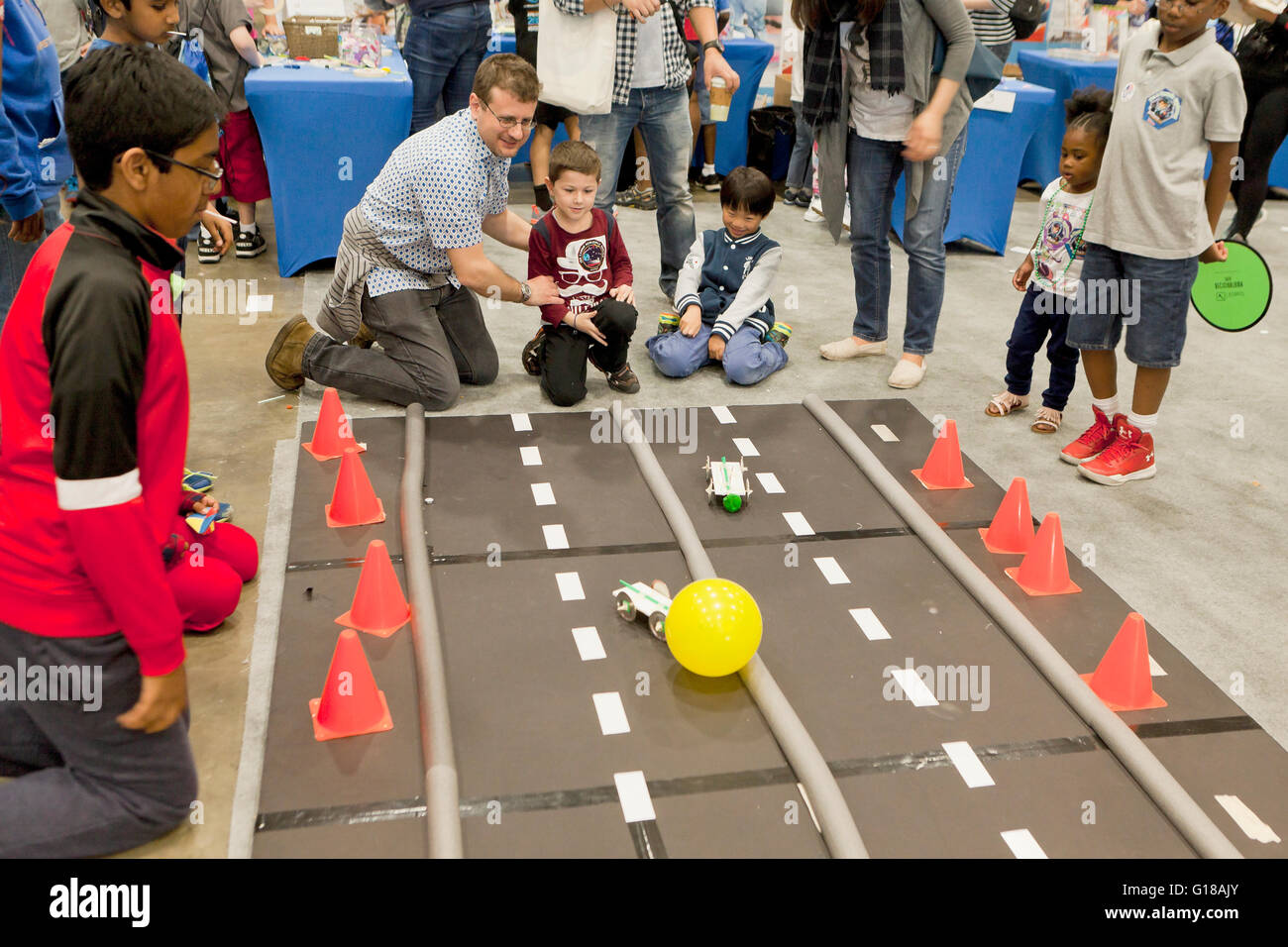 Children Using Remote Control Cars To Move Balloons At Science