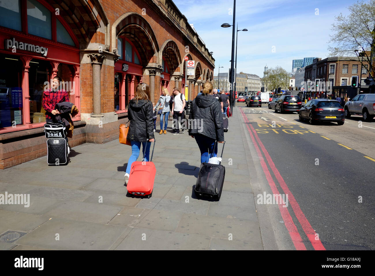 Women pulling luggage on pavement hi-res stock photography and images -  Alamy