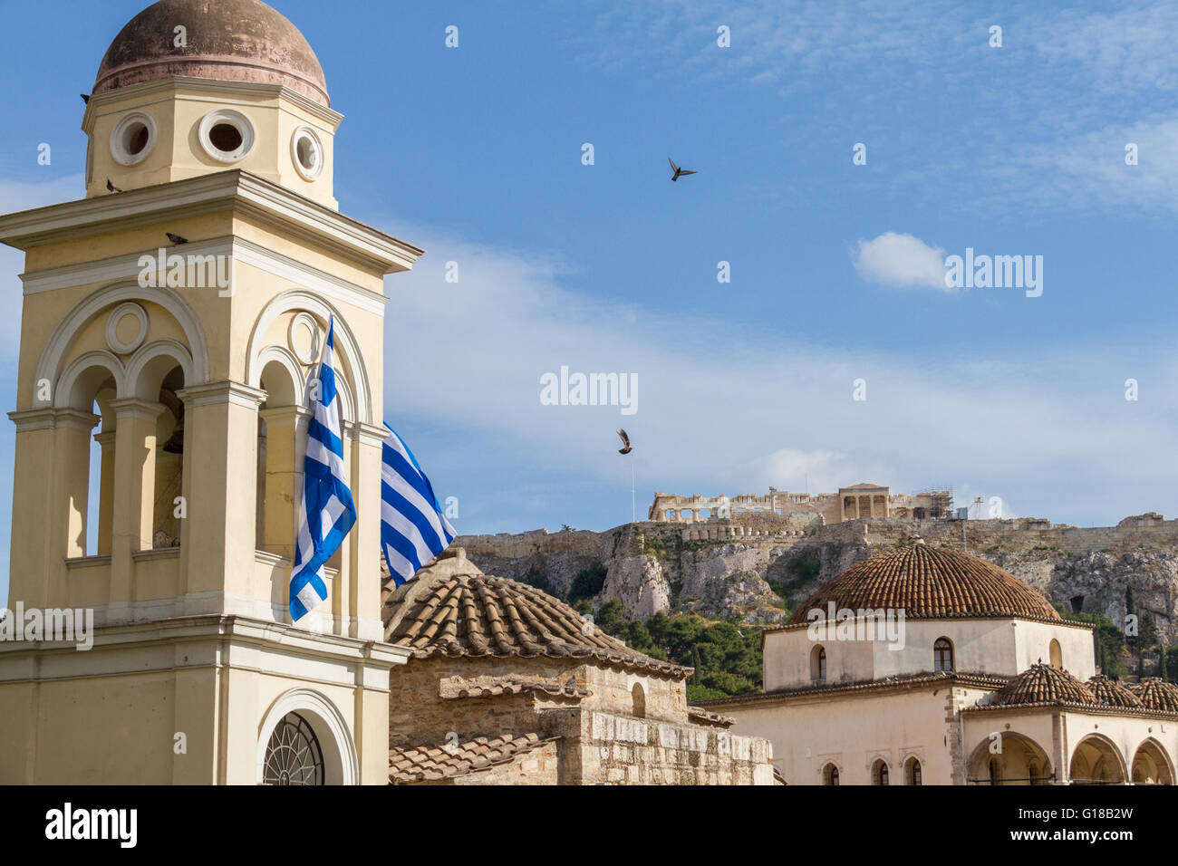 View of the Acropolis monument from Monastiraki Square as pigeons fly by. Afternoon photo in April 2016 Stock Photo