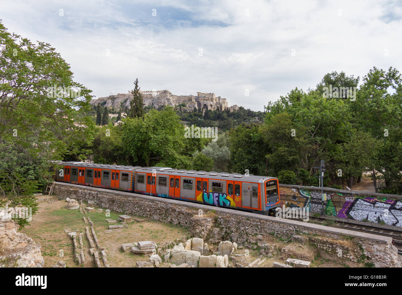 Passing train through Athens Ancient Agora with Acropolis in the background. Photo taken in spring 2016 Stock Photo