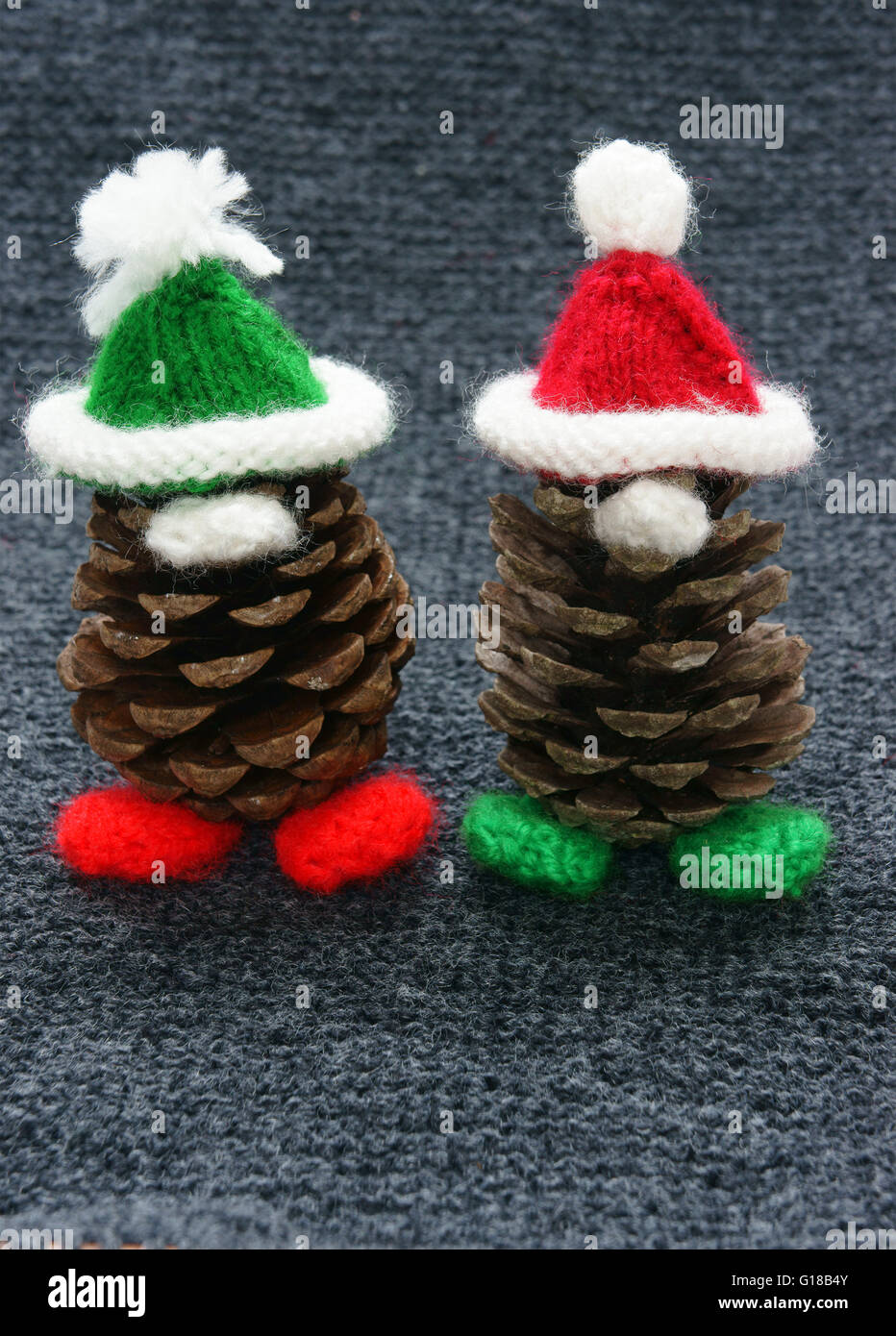 Christmas pine gnome, pinecone wear Xmas hat for decoration on winter holiday, with red, green yarn, homemade product by knitted Stock Photo