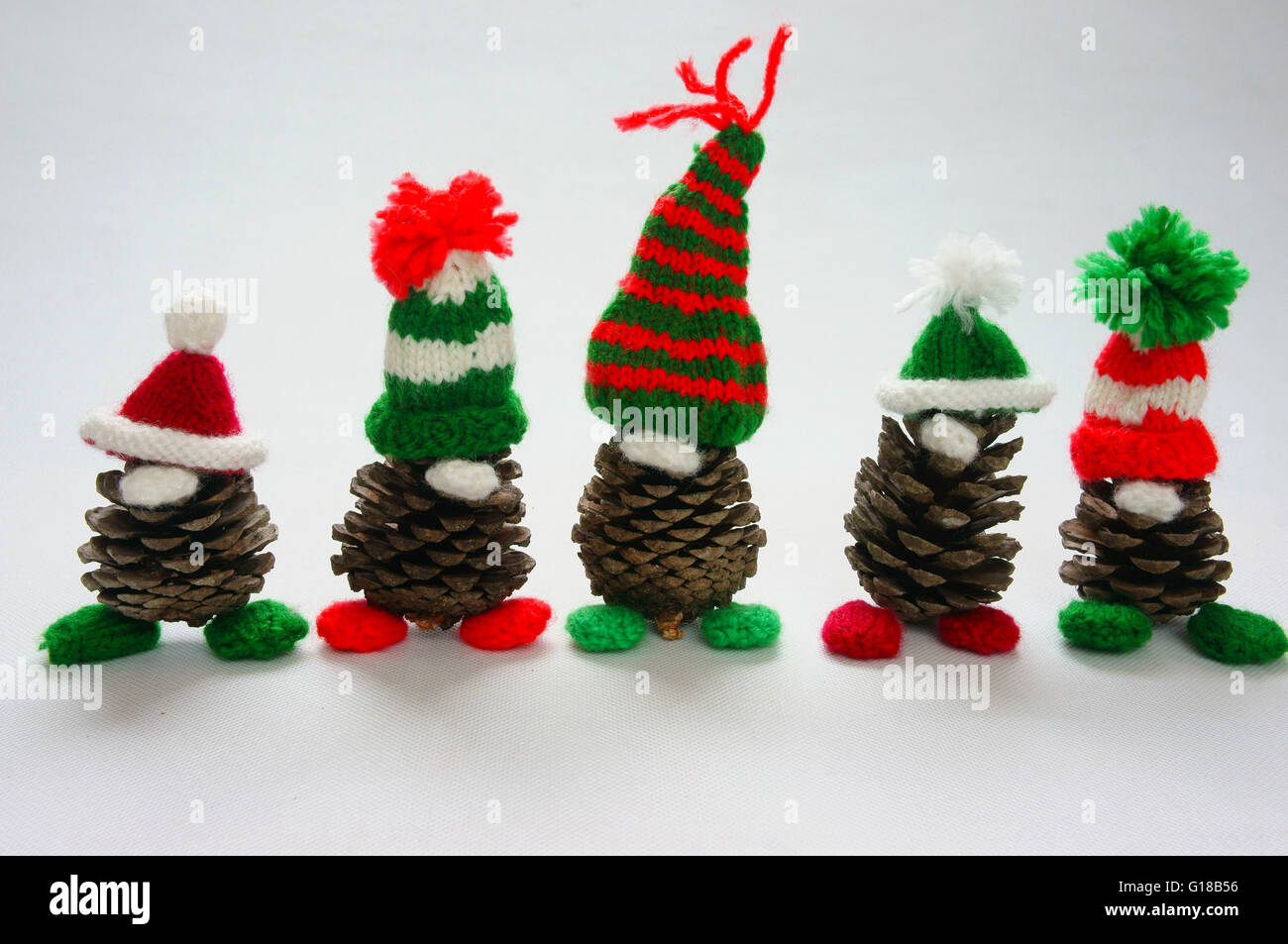 Christmas pine gnome on white background, Xmas pinecone wear Xmas hat for decoration on winter holiday, with red, green yarn, ho Stock Photo