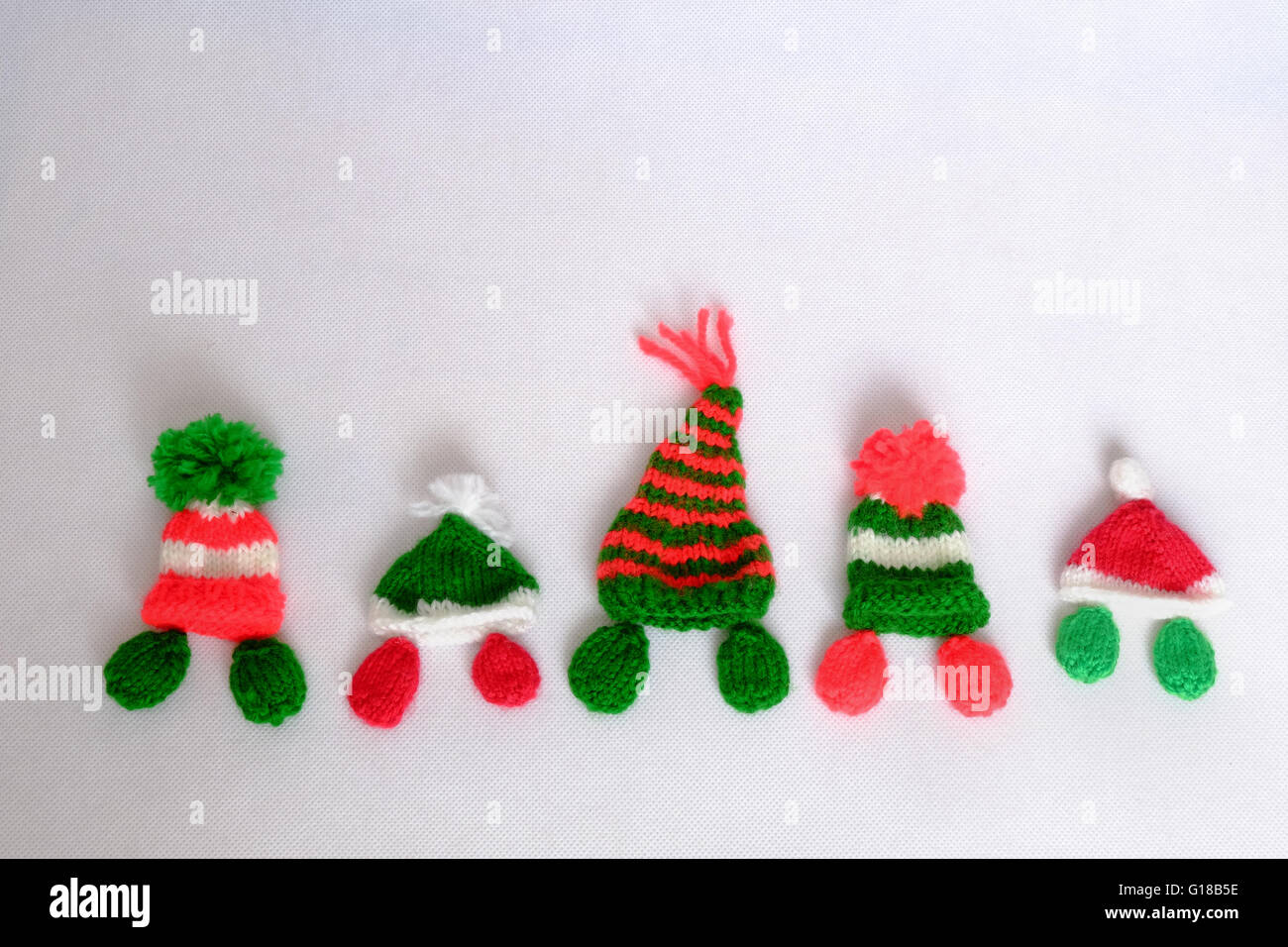 Christmas background,  handmade by knitted, hat knit from red and green, hand made product for winter holiday Stock Photo