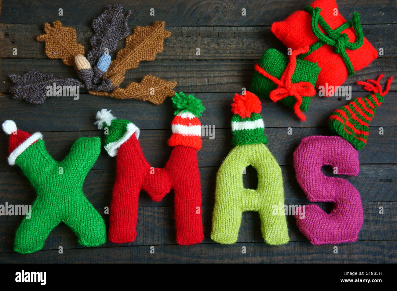 Christmas background, Xmas alphabet handmade by knitted, amazing ornament for noel as letter, gift, hat knit from red and green Stock Photo