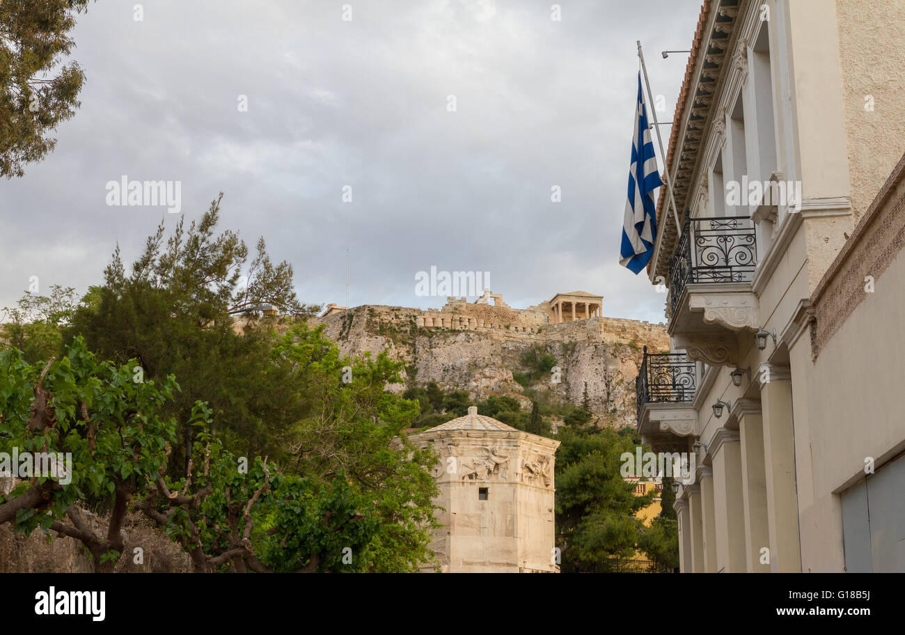 Athens, Plaka district view with flag, Roman Agora, Tower of Winds  and Acropolis. Photographed in an afternoon in April 2016. Stock Photo
