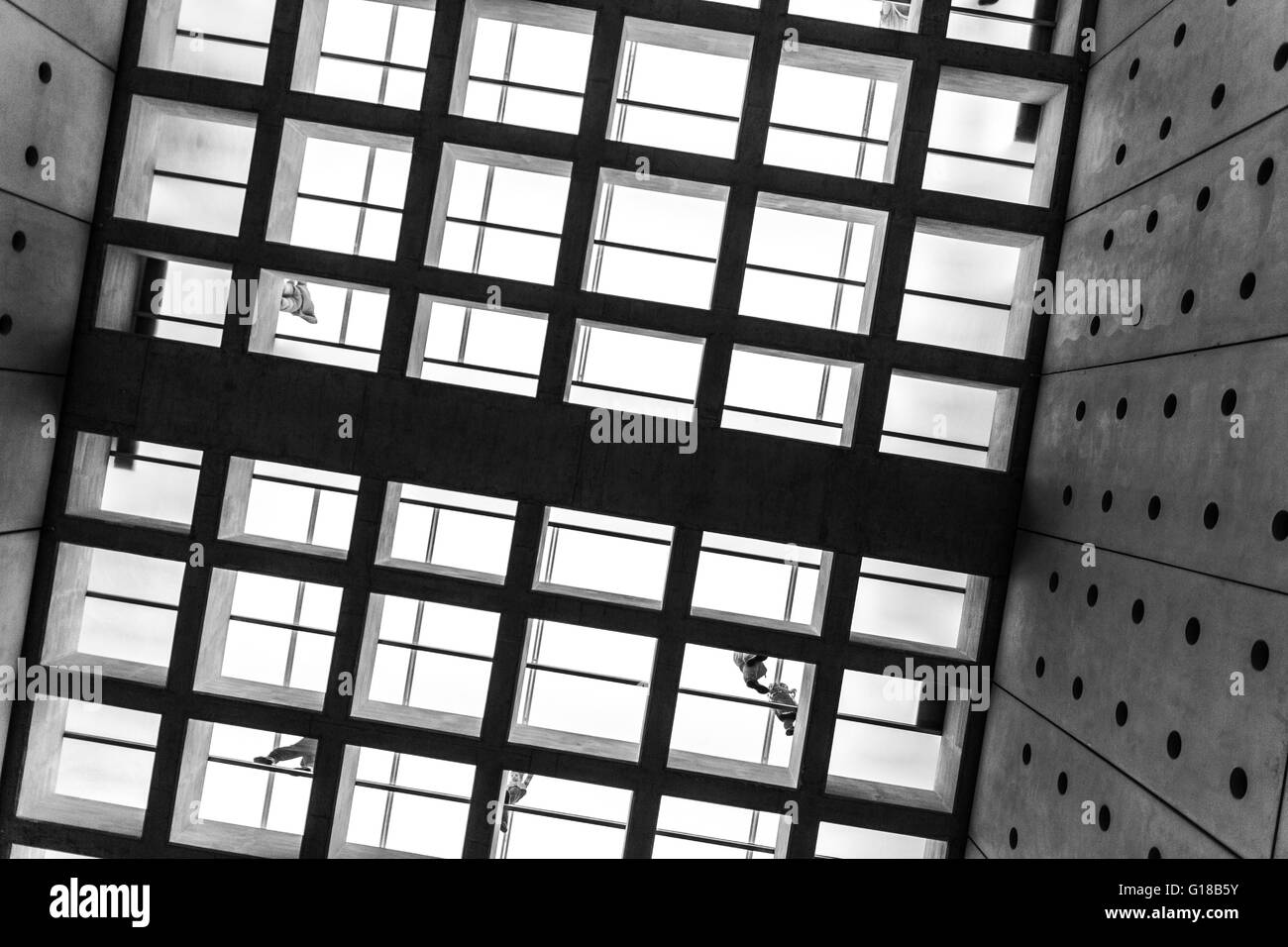 Square floor pattern, glass floor and walking people photographed in Black and White in the  Acropolis museum. Stock Photo