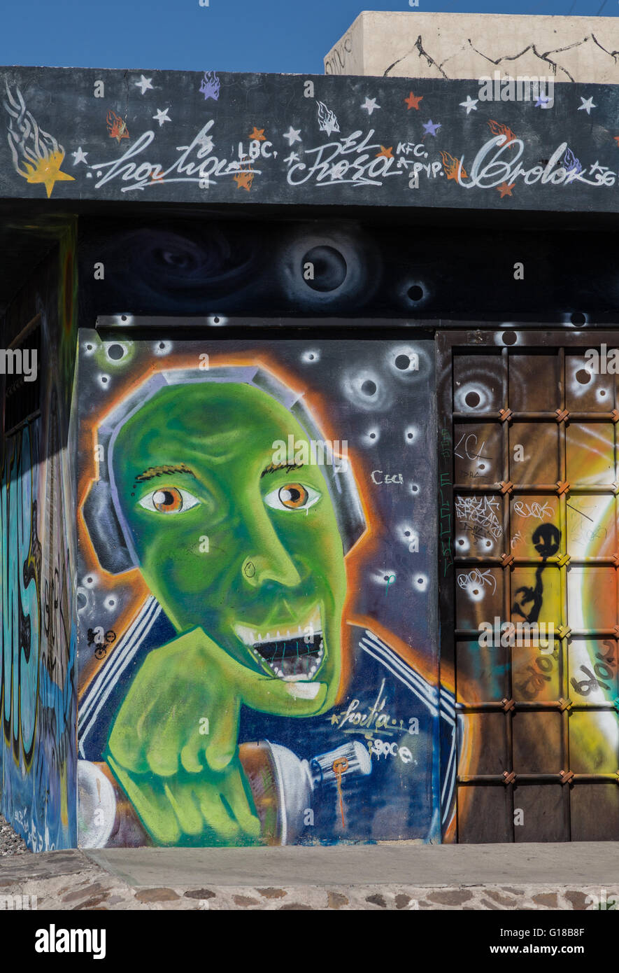 Urban art depicting green man wearing headphones having fun in the