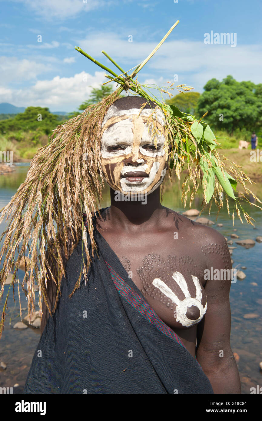 Young Surma woman with body paintings in front of the river, Kibish ...