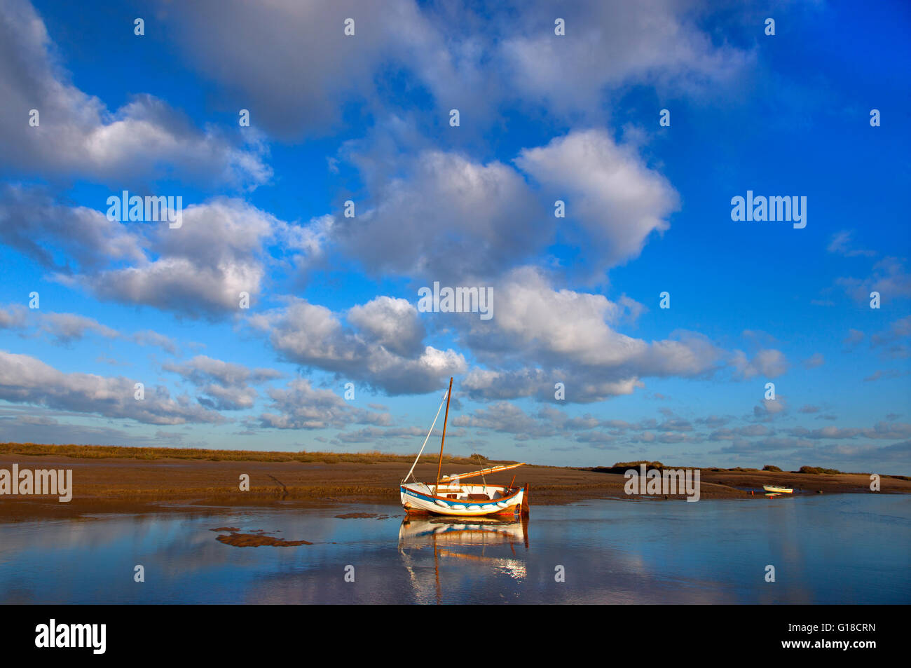 Moored boat on a Calm day at Brancaster Staithe Norfolk UK Winter Stock Photo