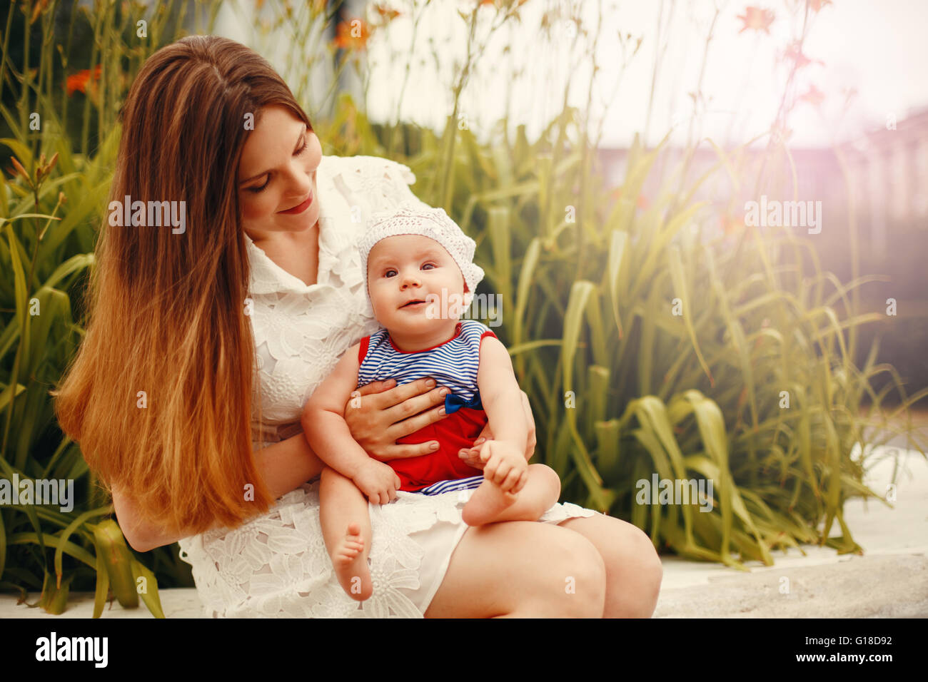 Girl sitting knees up smiling hi-res stock photography and images - Alamy