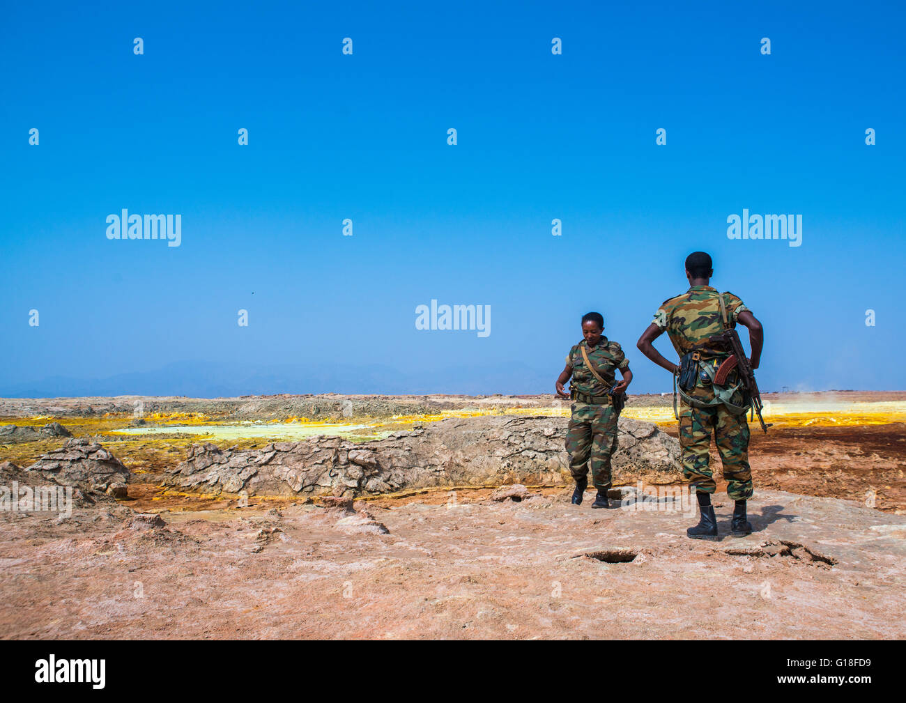 Ethiopian soldiers in front of colorful volcanic landscape in the danakil depression, Afar region, Dallol, Ethiopia Stock Photo