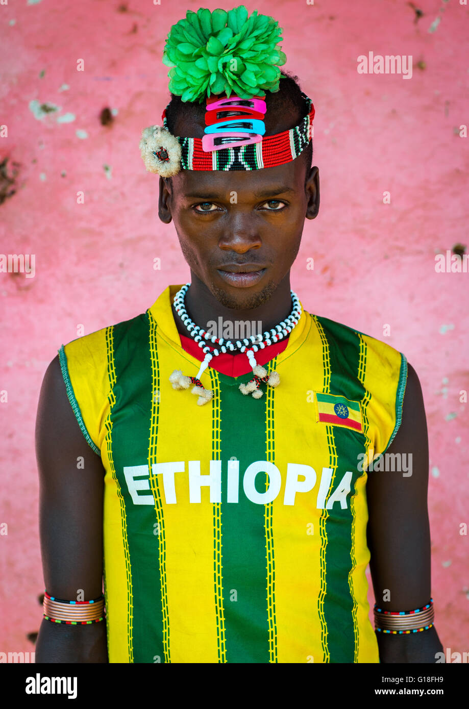 Portrait of a bana tribe man with green plastic flower in the hair, Omo valley, Key afer, Ethiopia Stock Photo