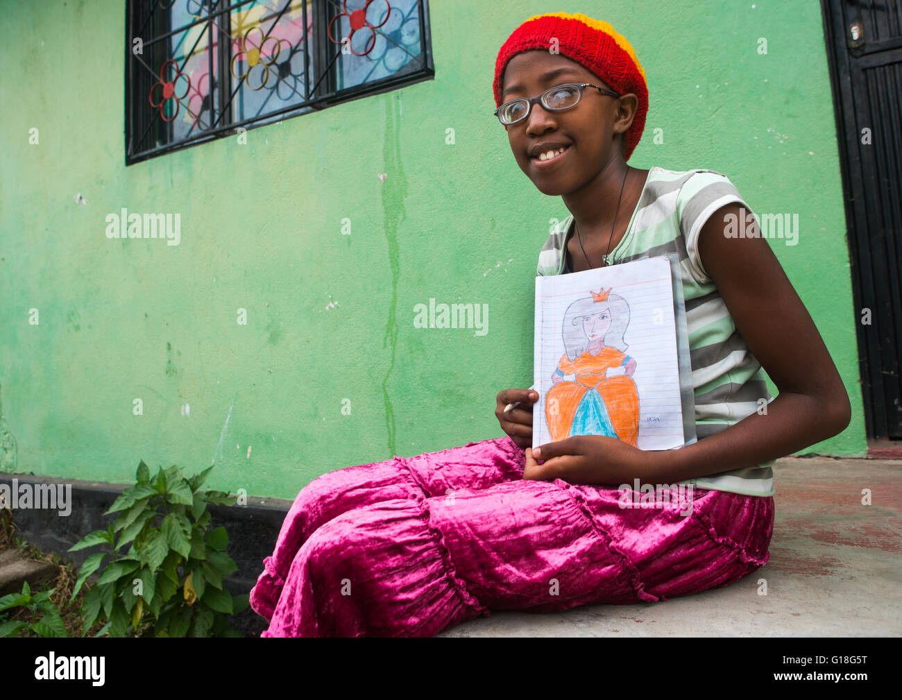 Rastafari girl called kizzy showing a princess she draws, Oromo, Shashamane, Ethiopia Stock Photo