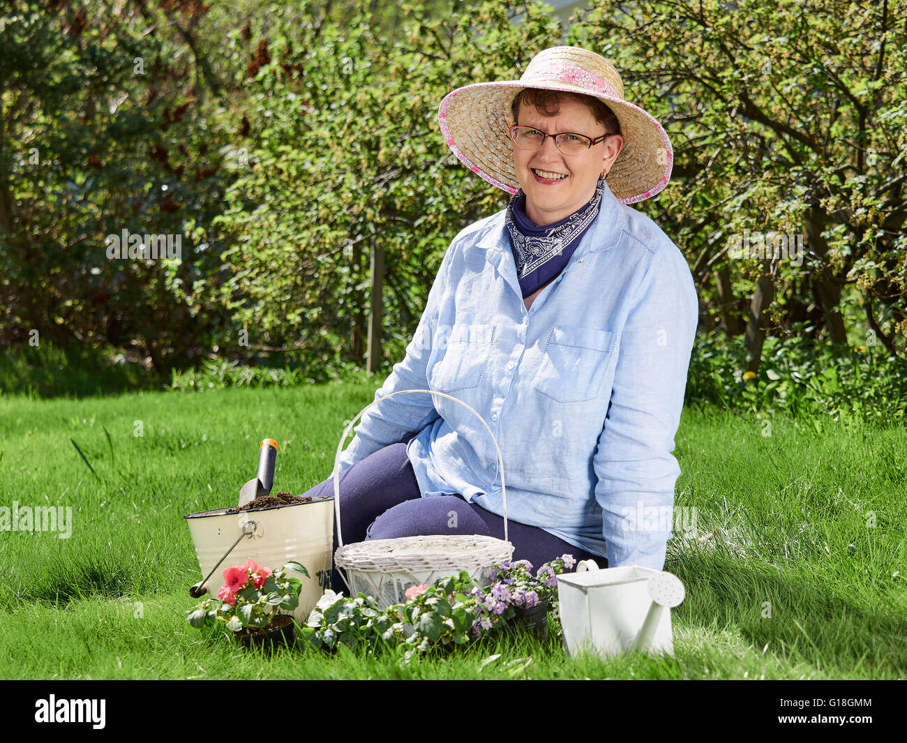 Mature woman gardening, she planting flowers Stock Photo