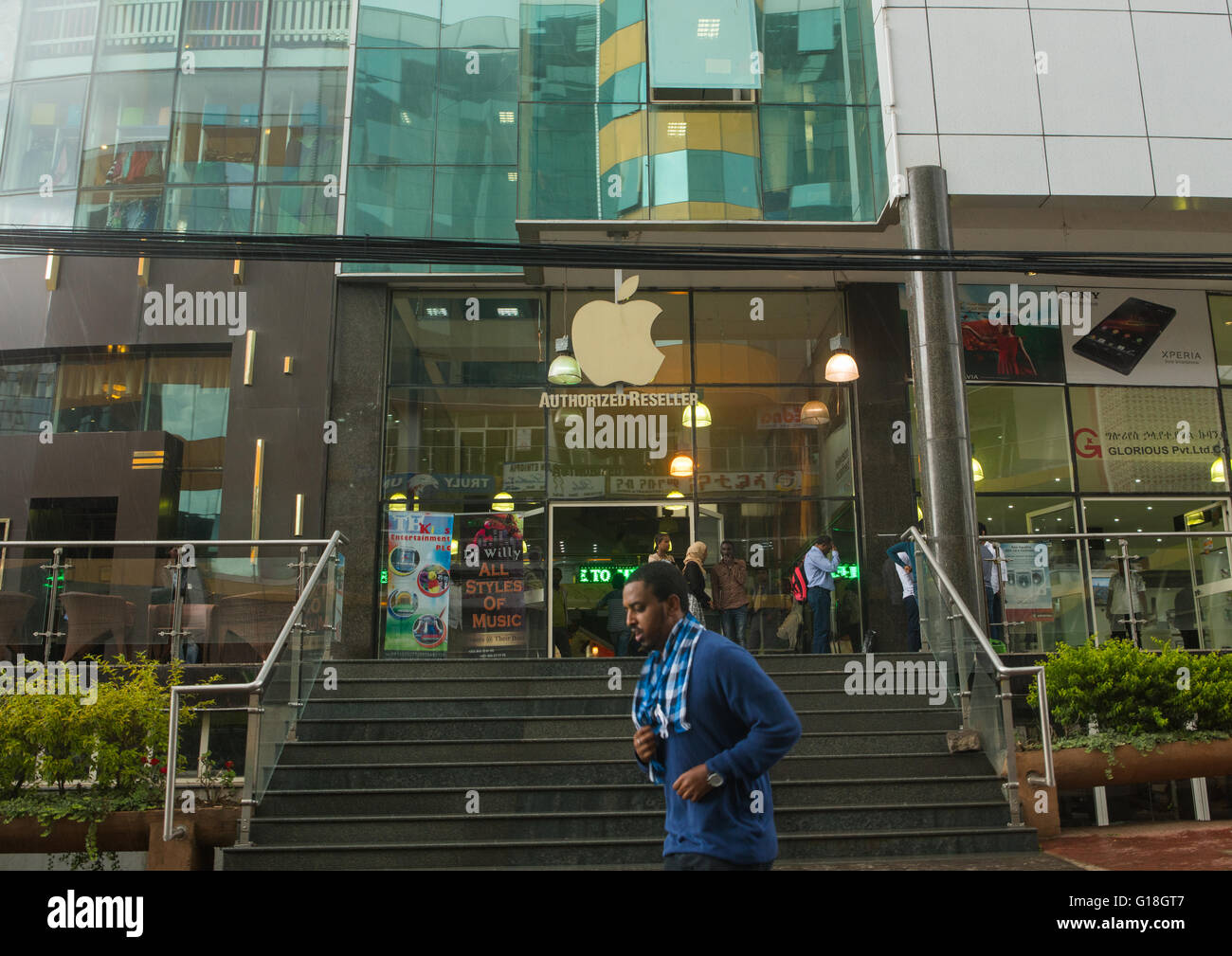 Man passing in front of a mall with iphone shop, Addis abeba region, Addis ababa, Ethiopia Stock Photo