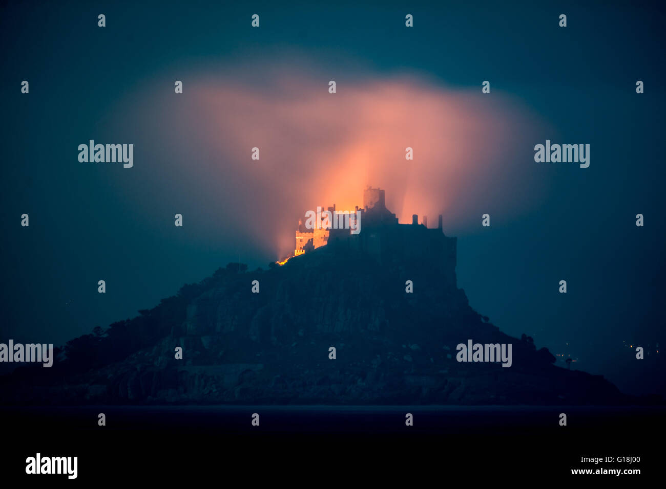 Mounts Bay, Cornwall, UK. 10th May 2016. UK Weather. After a misty day, the lights at St Michaels mount cast an eery glow in the late night sky Credit:  Simon Maycock/Alamy Live News Stock Photo