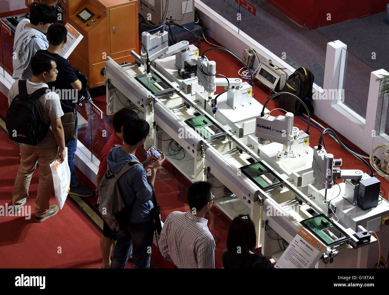 Beijing, China. 11th May, 2016. Visitors view a model of an automatic