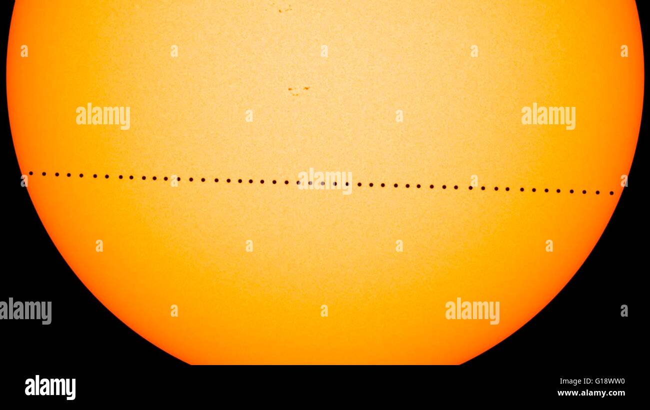 Composite image showing the planet Mercury in silhouette, lower third of image, as it transits across the face of the sun May 9, 2016 created with visible-light images from the Helioseismic and Magnetic Imager on SDO. Mercury passes between Earth and the sun only about 13 times a century, with the previous transit taking place in 2006. Stock Photo