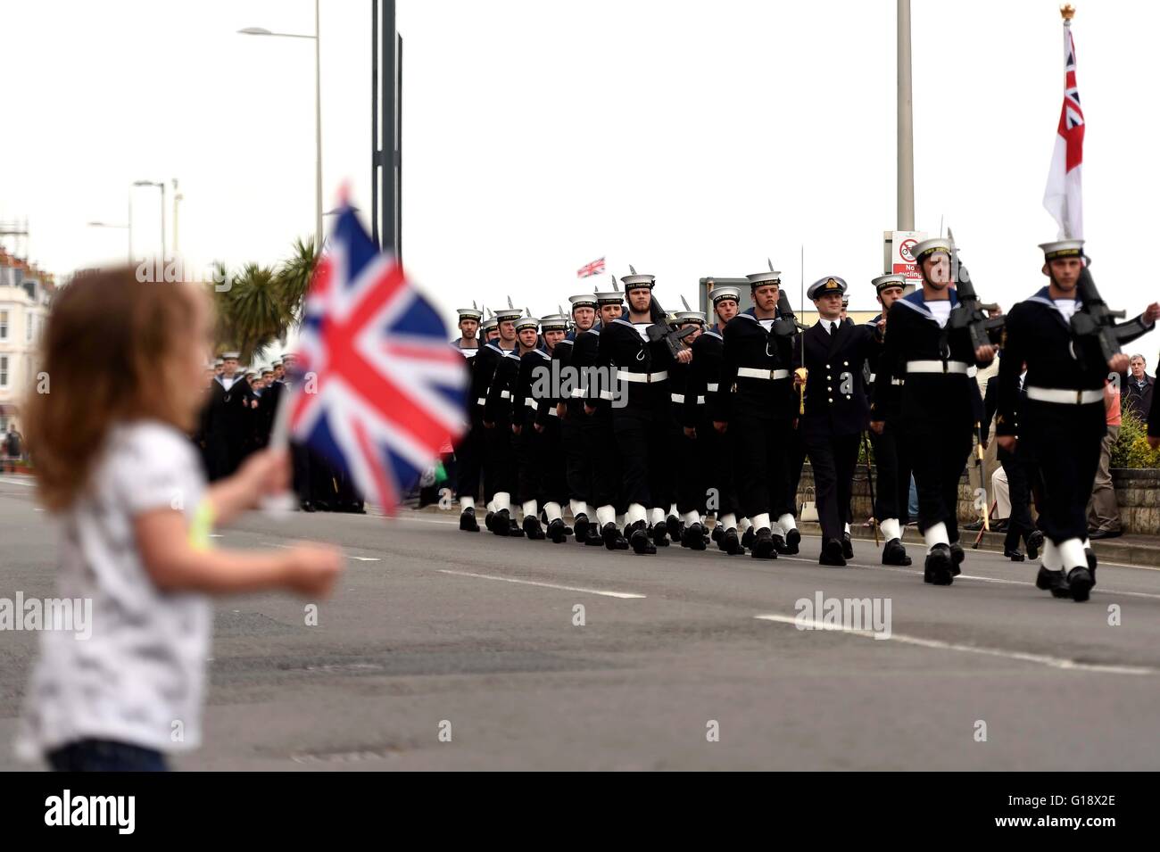 Girl with a British flag during a military parade, UK Stock Photo