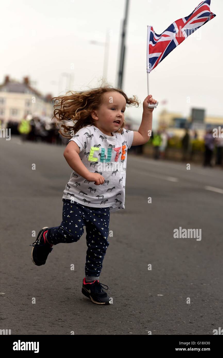 Girl with a British flag during a military parade, UK Stock Photo