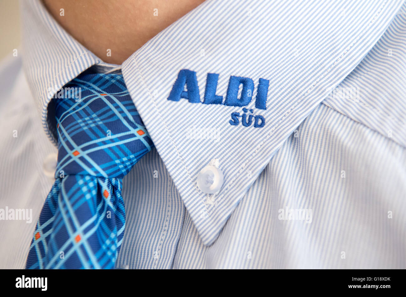 An Aldi worker in his uniform at a redesigned Aldi supermarket which