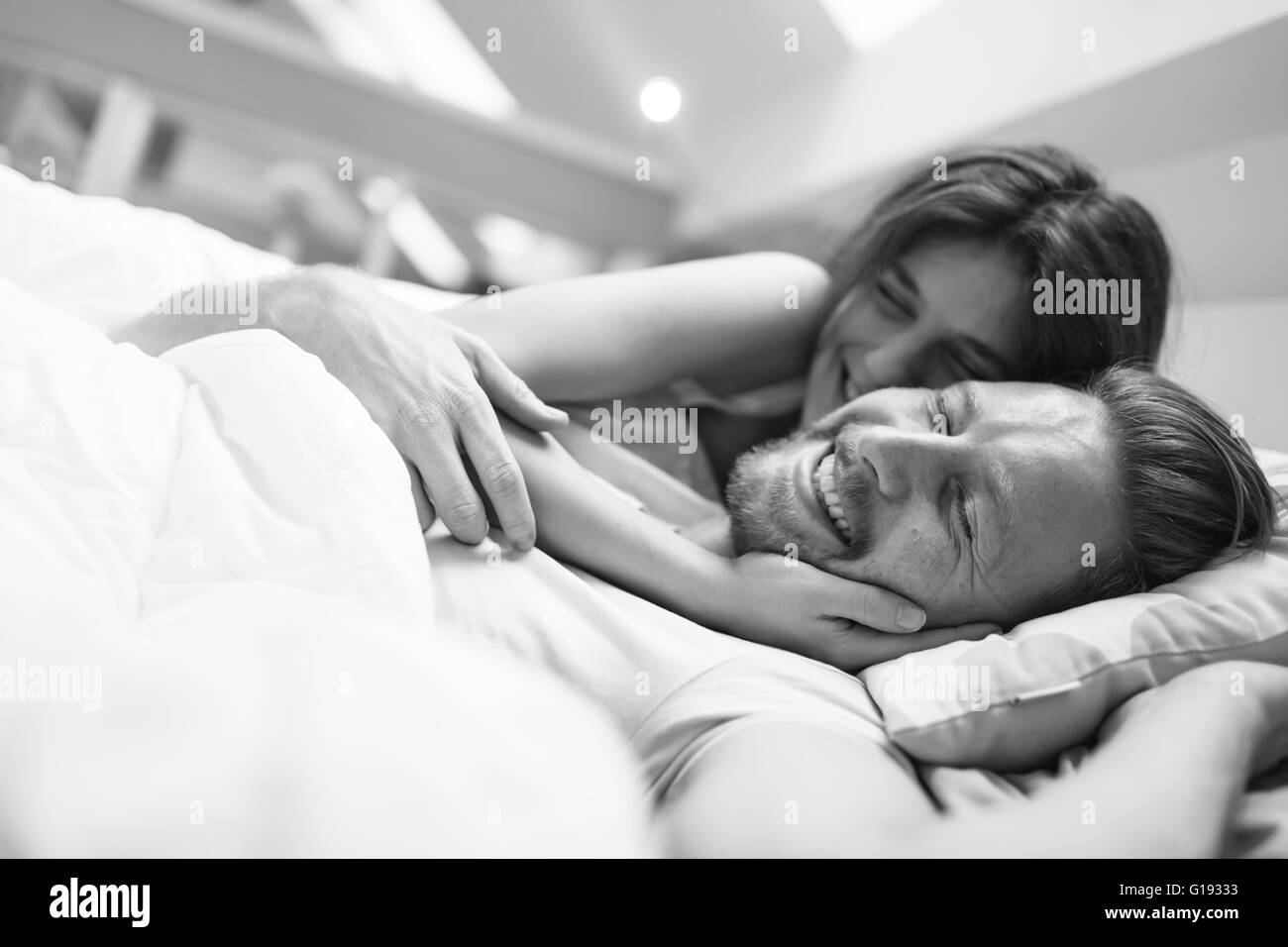 Romantic couple in love lying on bed and being passionate Stock Photo