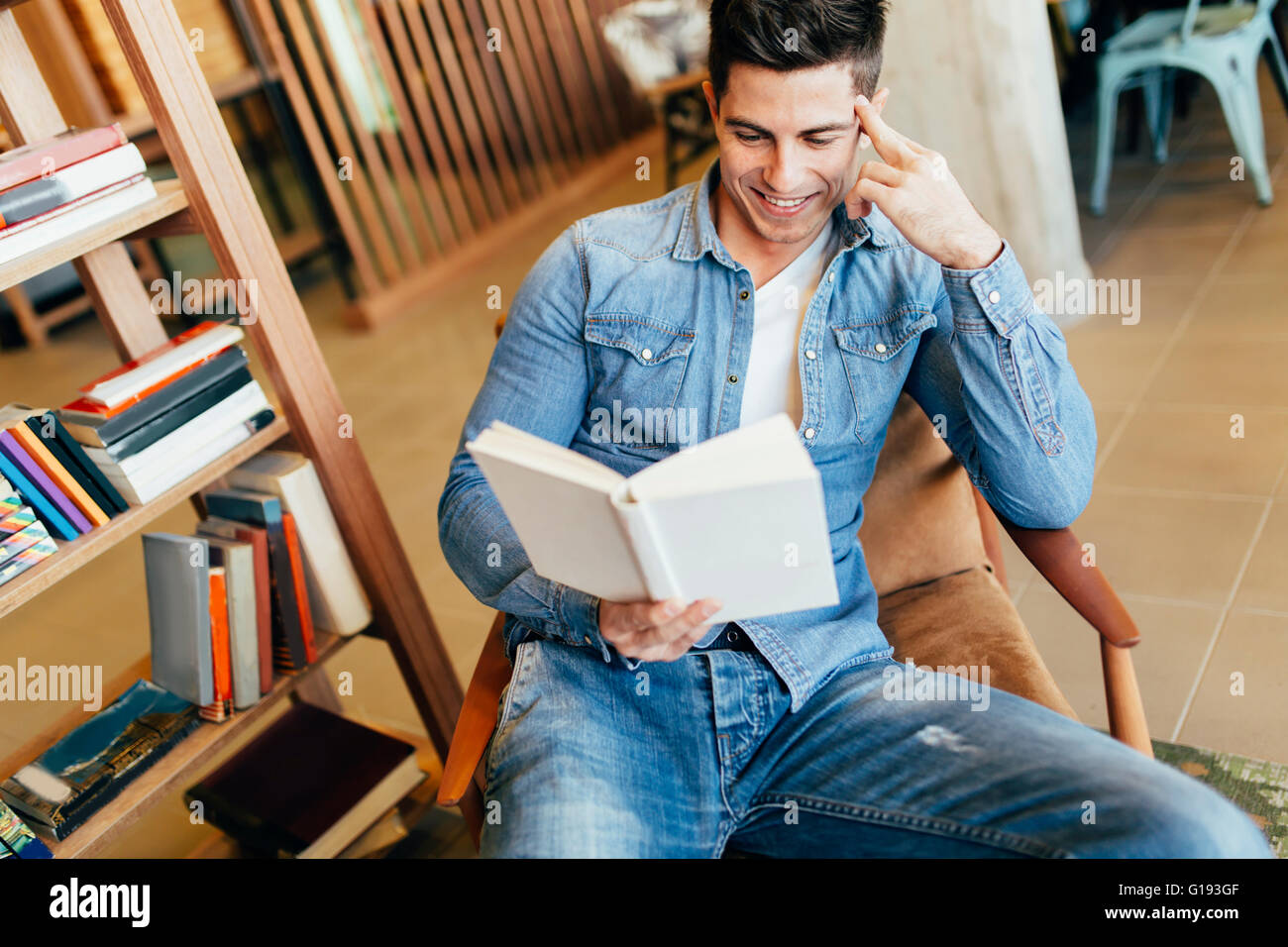Handsome man studying by reading books and preparing for exam Stock
