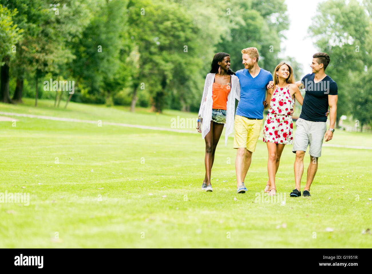 Cheerful friends walking in nature outdoors and having a good time Stock Photo