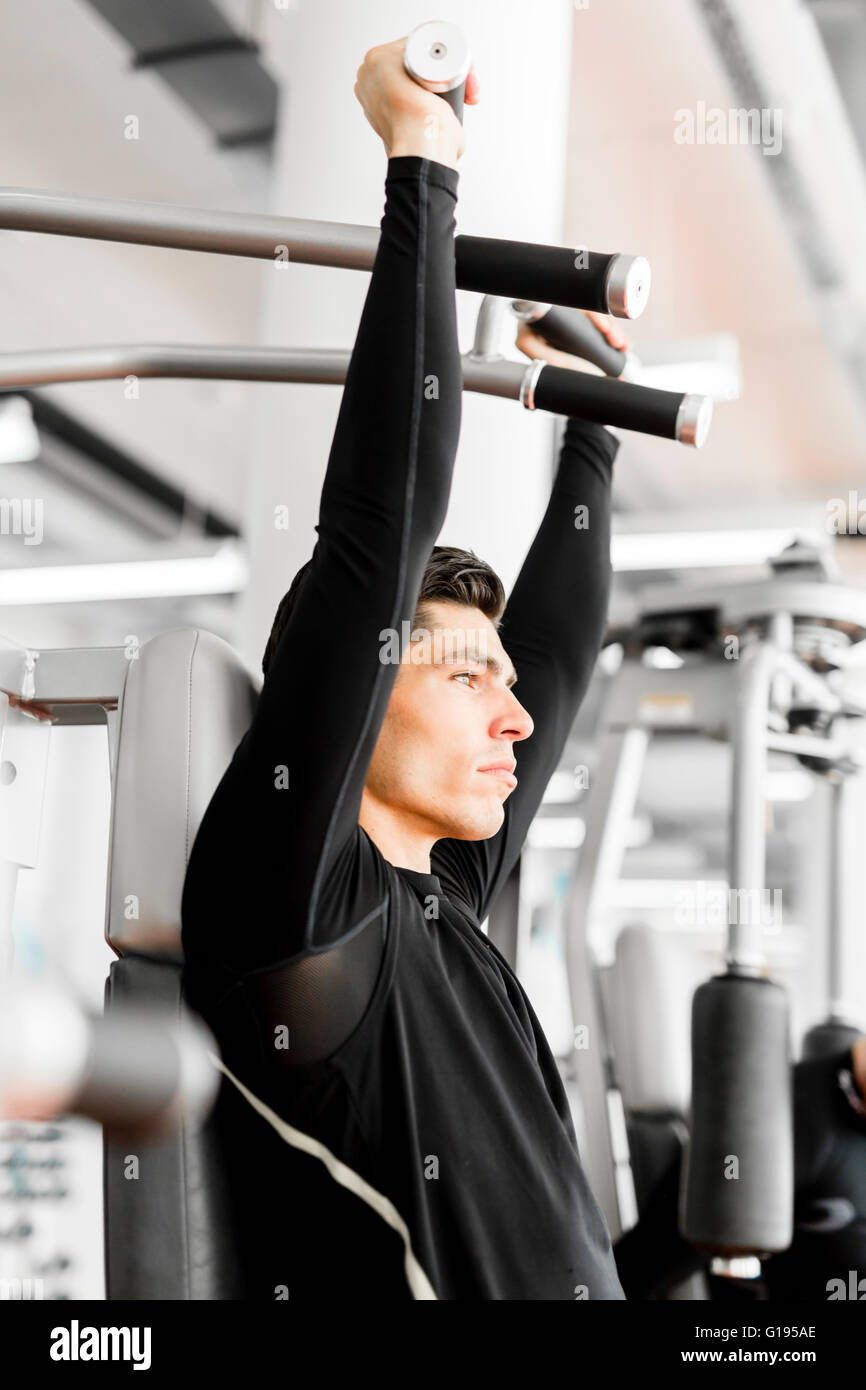 Young handsome man working out in a  gym and living a healthy lifestyle Stock Photo