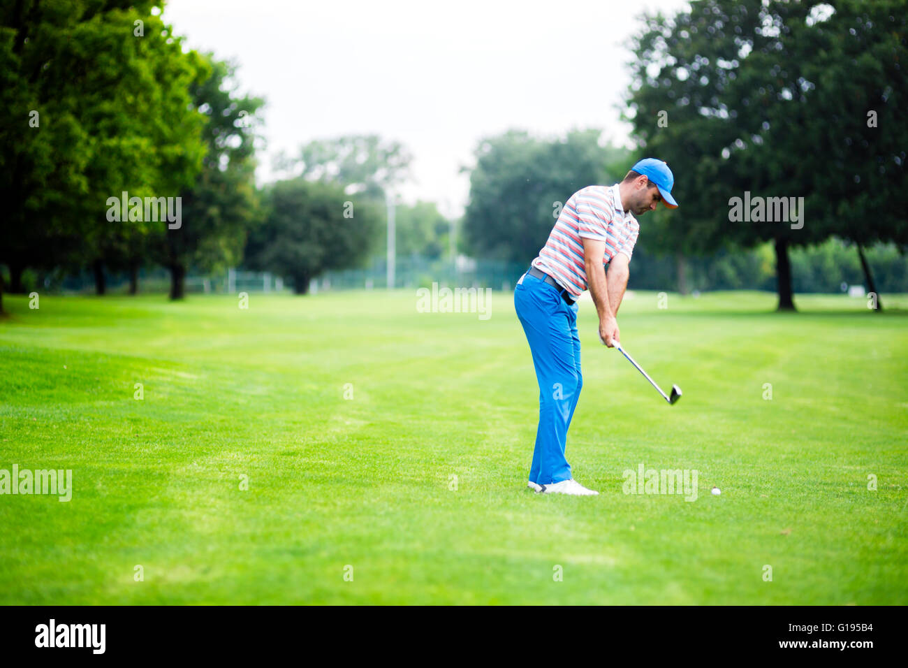 Golfer practicing and concentrating before and after shot during a nice sunny day Stock Photo