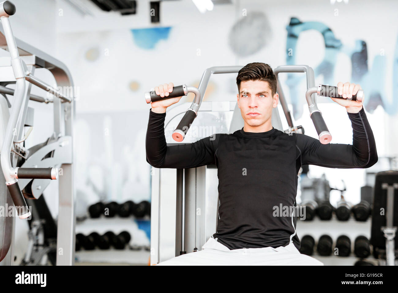Portrait of a handsome young man training in a gym and looking towards the camera Stock Photo