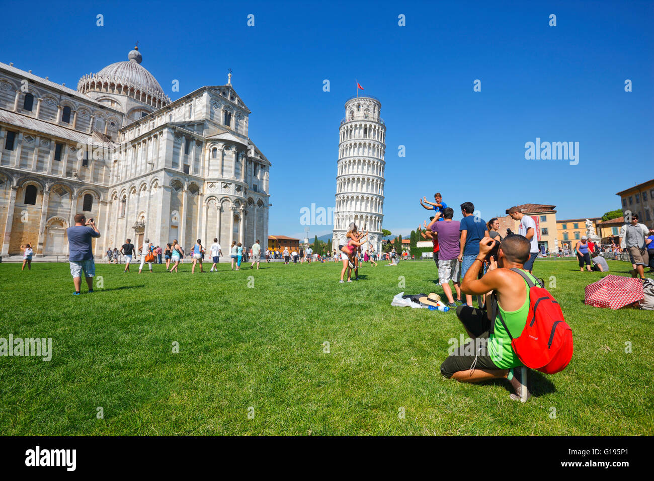 Group of tourists taking photos of the Leaning Tower of Pisa, Italy Stock Photo