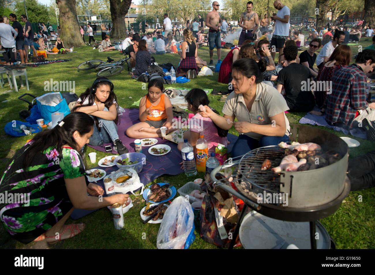 Hackney. London Fields park. Sunday afternoon in the sun. An Ecuadorian
