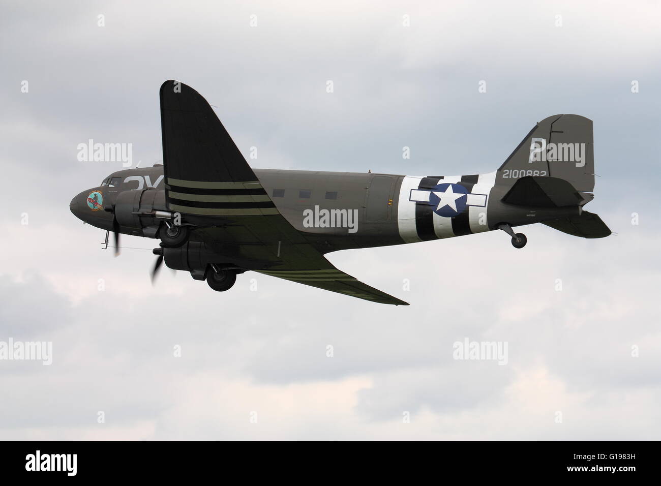 Douglas C-47A Skytrain, military version of the DC-3 Dakota,in USAAF D-Day markings making a flypast at Abingdon, UK Stock Photo