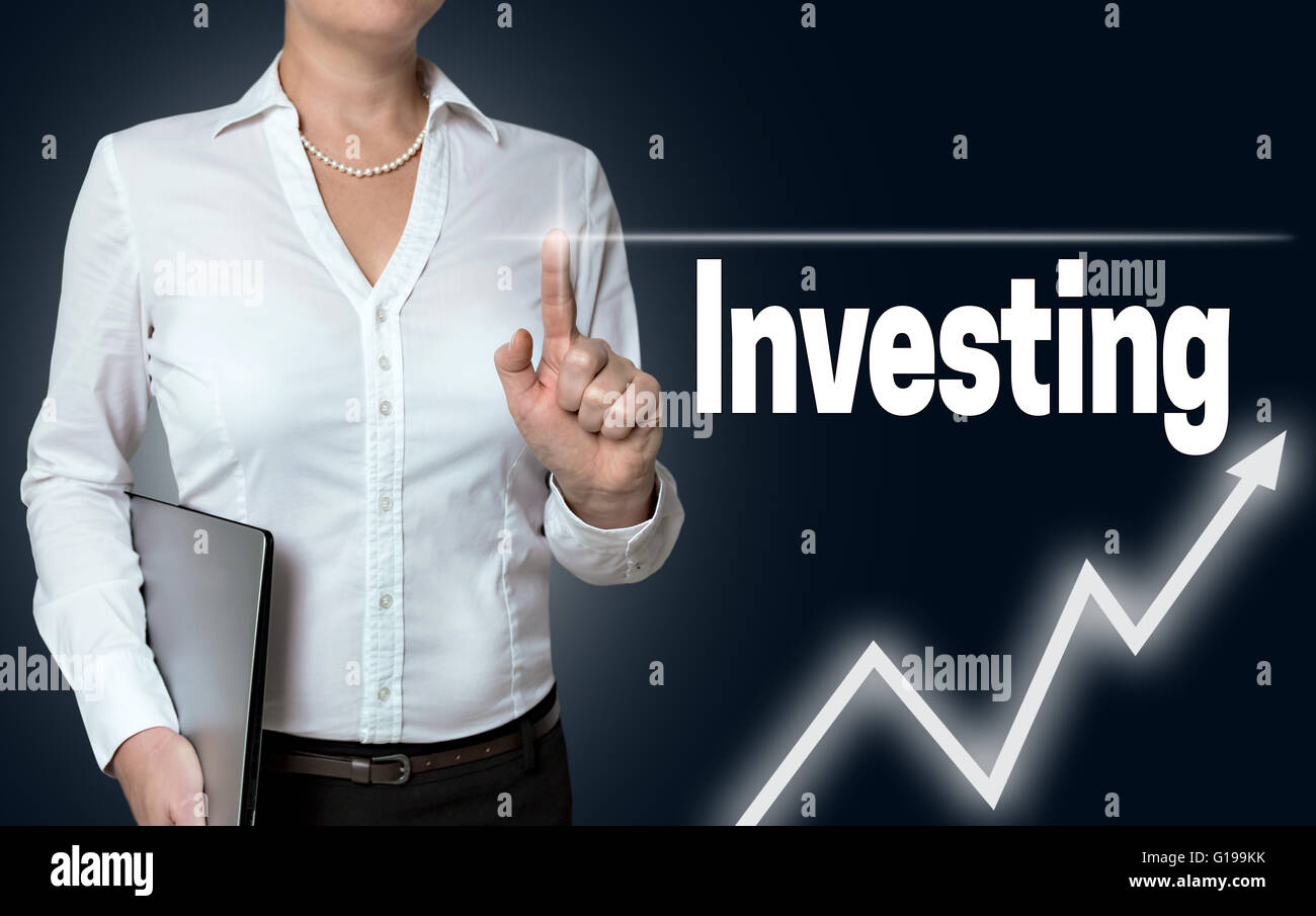 investing touchscreen is operated by businesswoman. Stock Photo