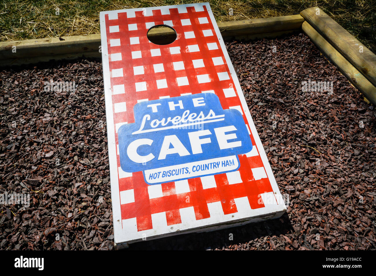 A red checkered tablecloth graphic art of the Loveless Motel & Cafe motif Cornhole game board on the grounds in Nashville TN Stock Photo