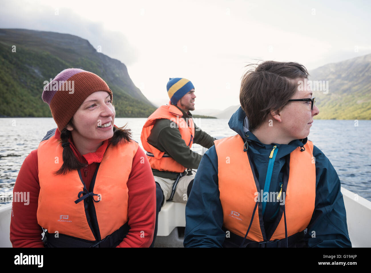Female hikers on STF water taxi across lake Teusajaure, Kungsleden trail, Lapland, Sweden Stock Photo