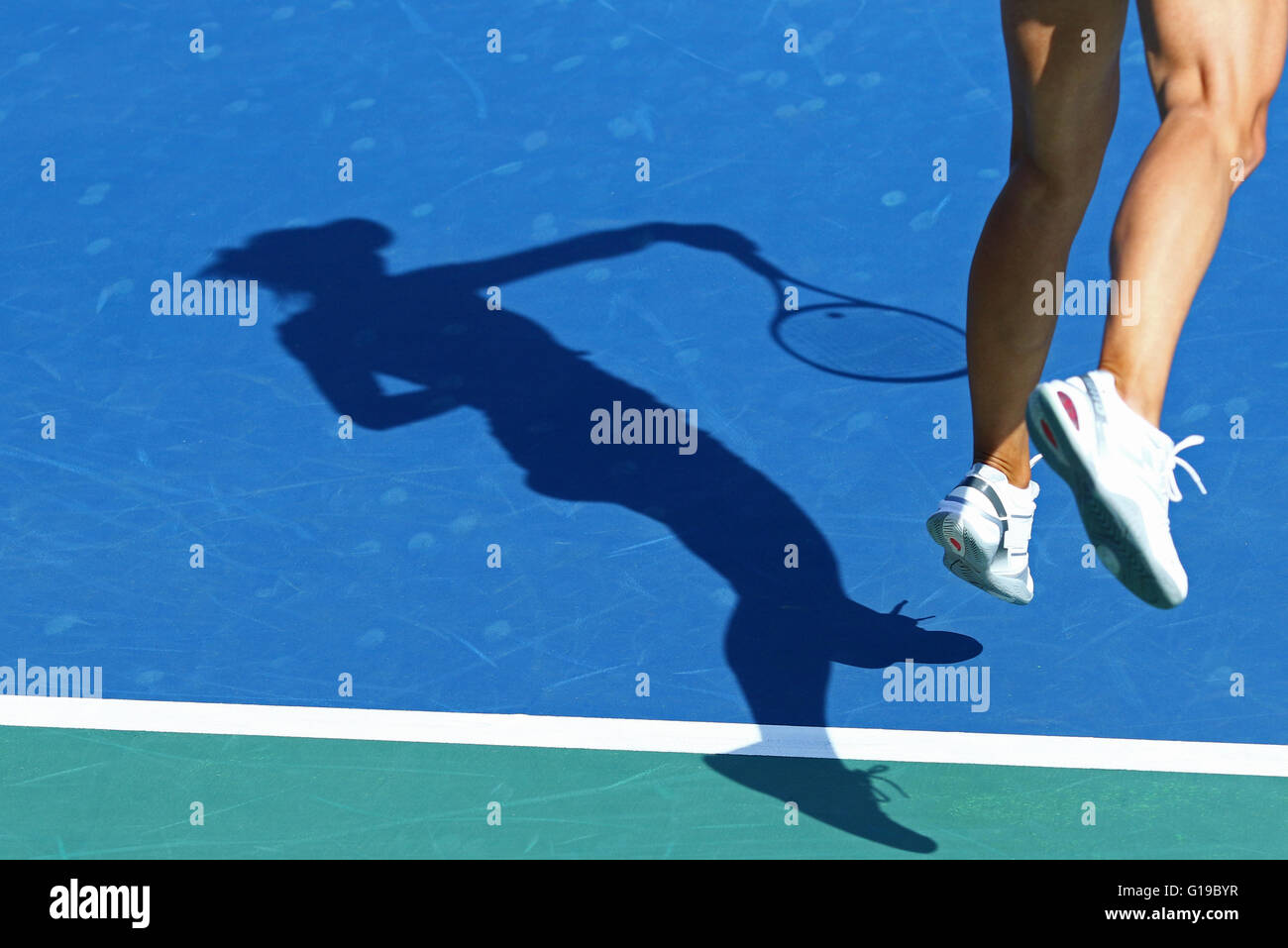Shadow of woman tennis player, serving the ball Stock Photo