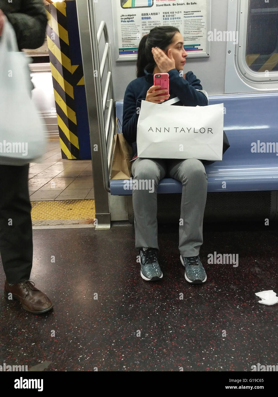 A Lord & Taylor shopper with her purchase on the subway in New York on April 21, 2016. (© Richard B. Levine) Stock Photo