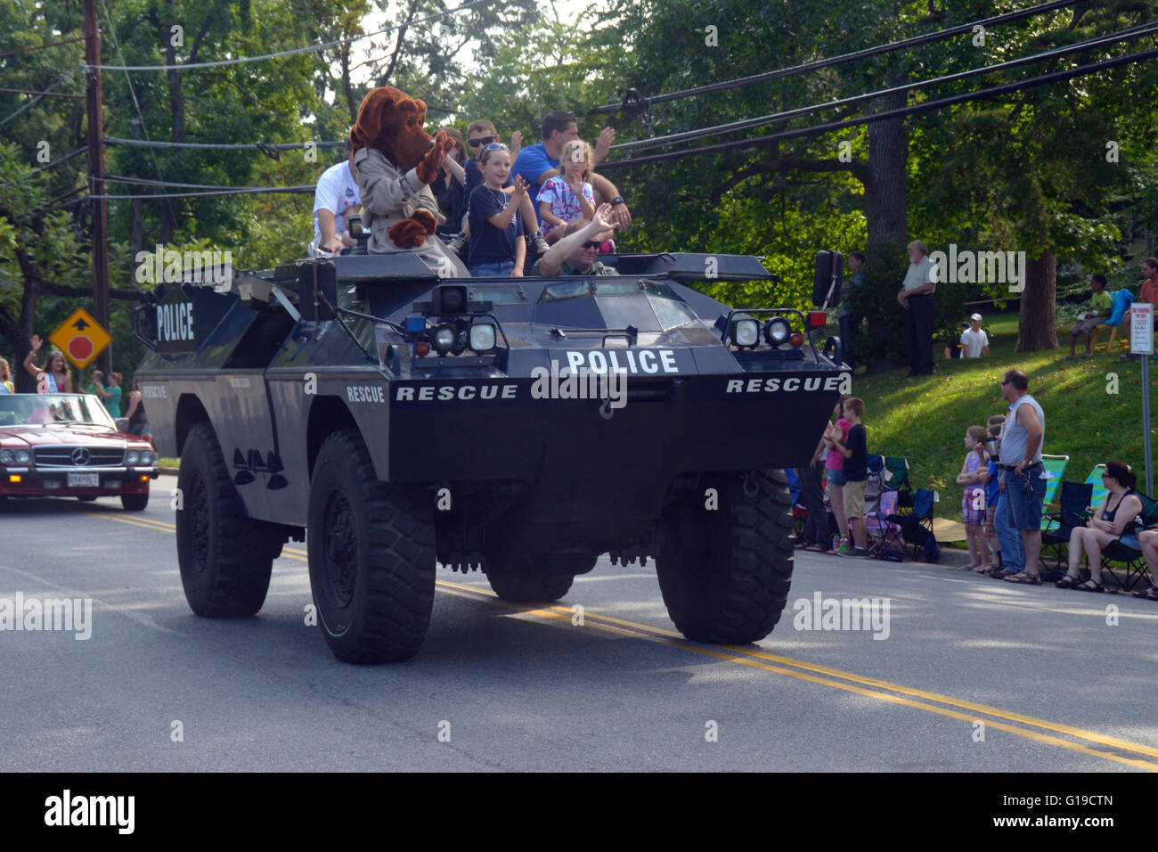Police armored personnell carrier with the Magruff the crime  dog and children  in a parade Stock Photo