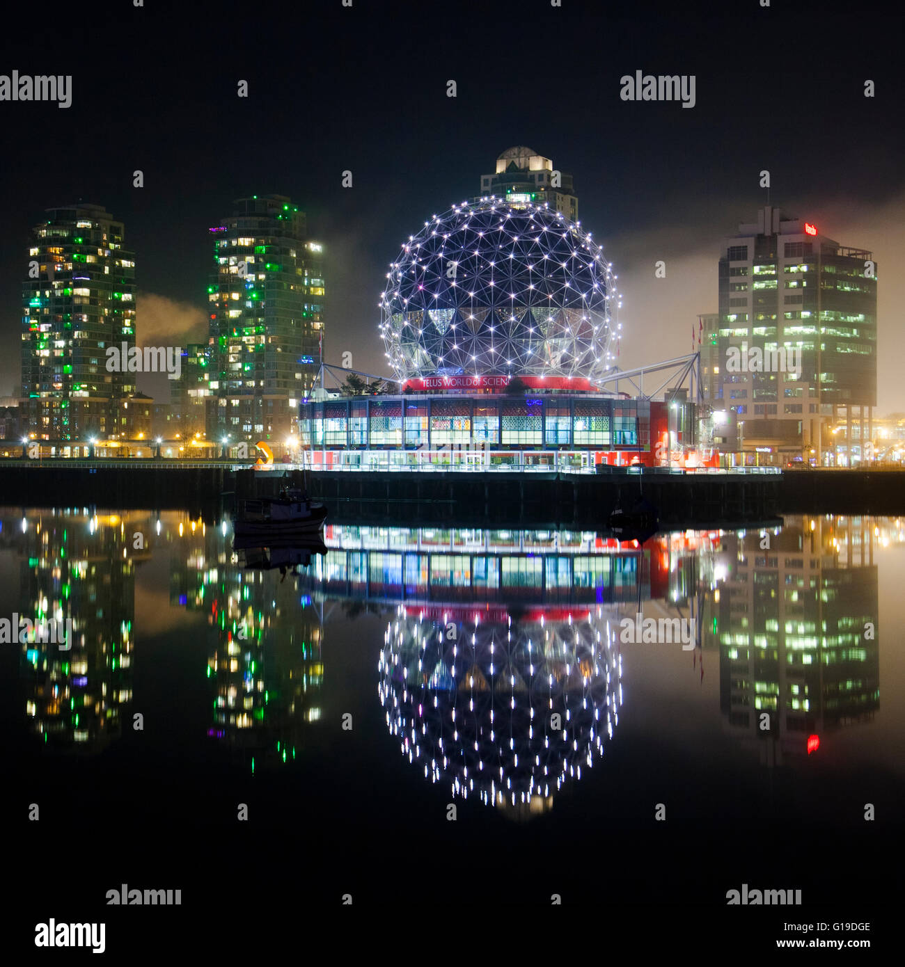 The Telus World of Science (Science World) is reflected in False Creek, Vancouver, BC. Stock Photo