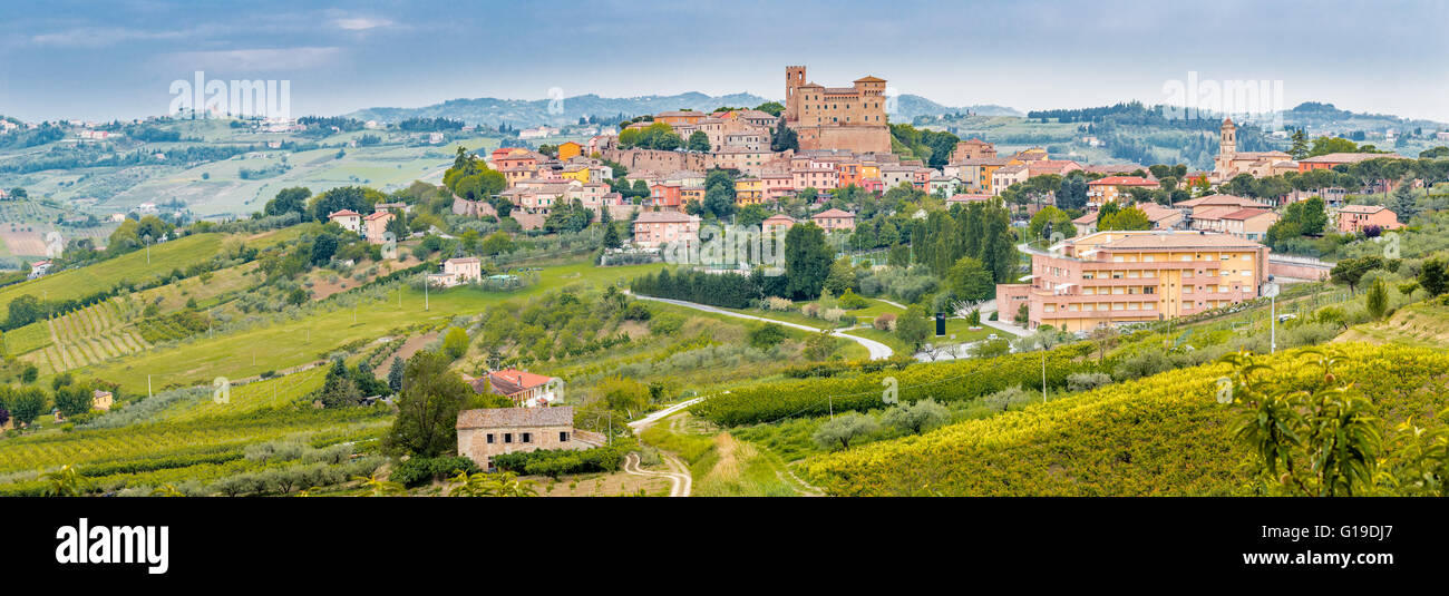 the medieval castle overlooking the hilly countryside surrounding the colorful houses of the charming mountain town of Longiano, near Cesena, Italy Stock Photo