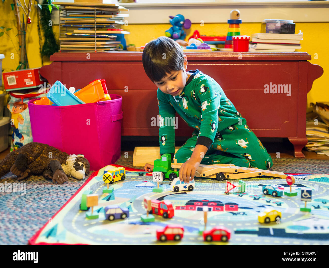 Young boy playing with wooden cars Stock Photo - Alamy
