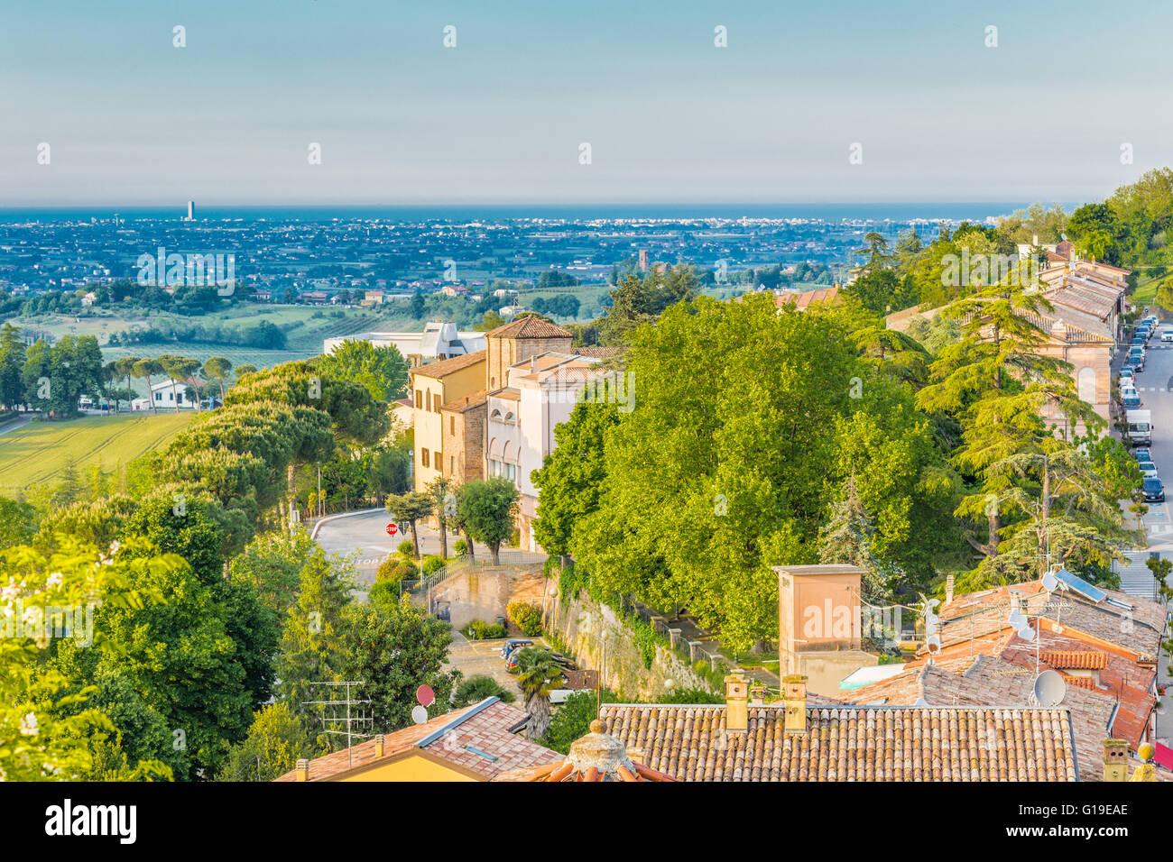 Panorama of the medieval village of Longiano in the Romagna hills near Cesena in Italy, with its ancient buildings and the sea in the distance on the horizon Stock Photo