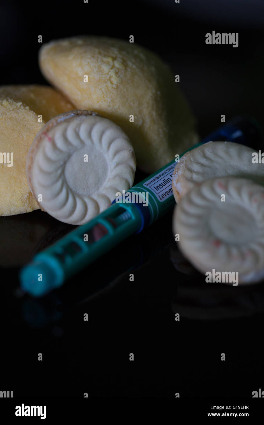 Insulin pen with blood sugar meter & test strip,used in the treatment of Diabetes mellitus.High carbohydrate foods also featured Stock Photo