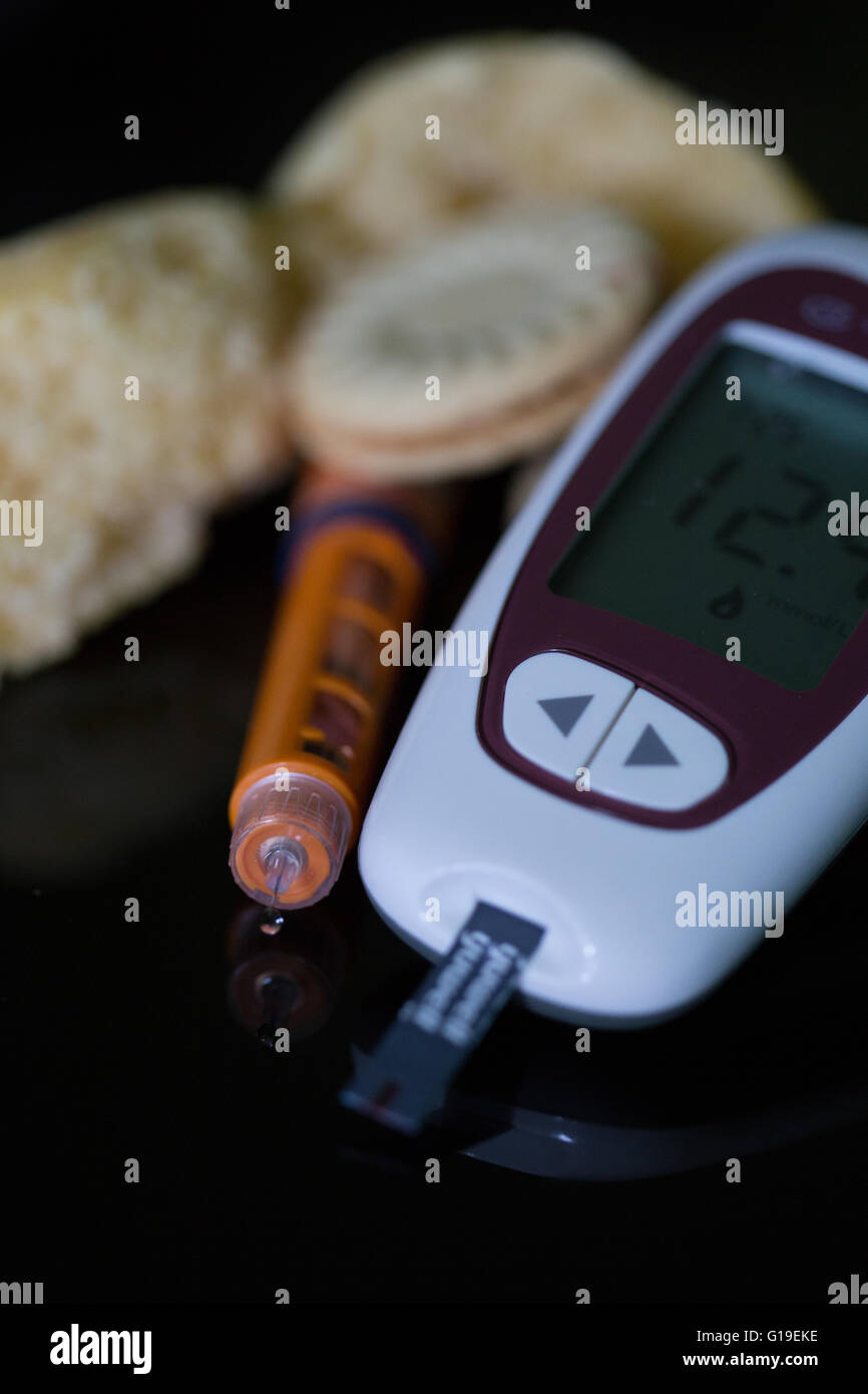Insulin pen with blood sugar meter & test strip,used in the treatment of Diabetes mellitus.High carbohydrate foods also featured Stock Photo