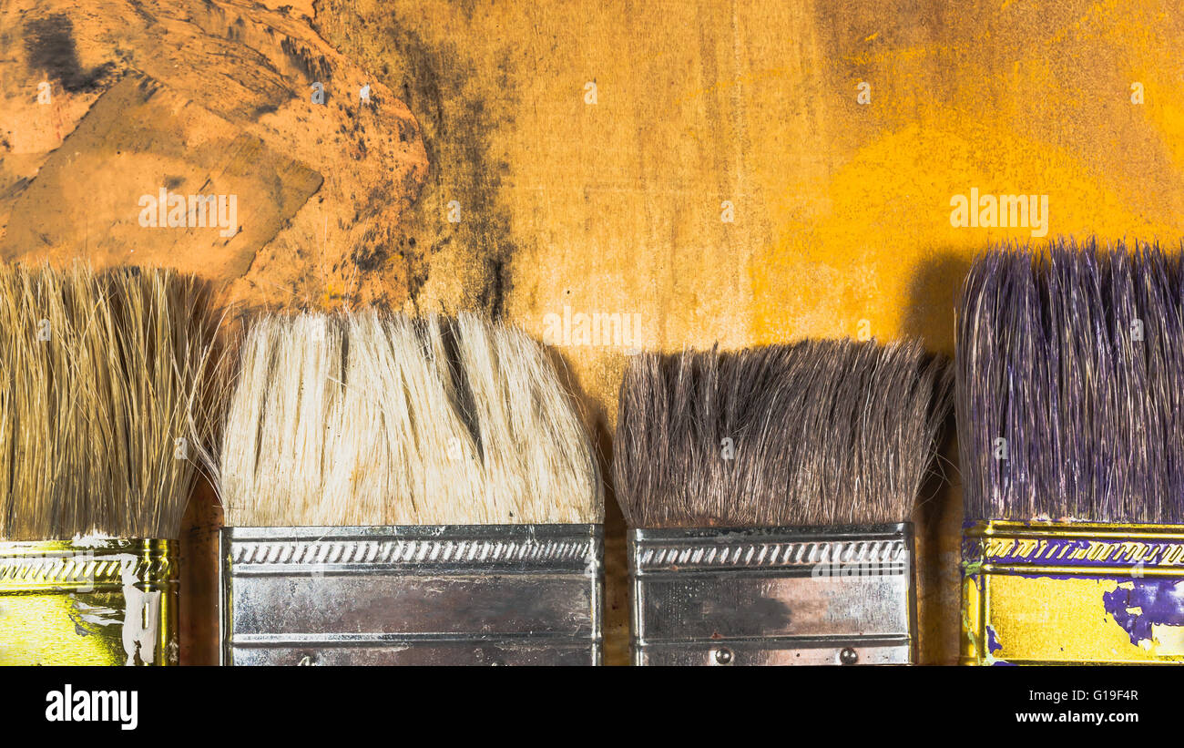 Oil paint brushes on wood painted background Stock Photo - Alamy