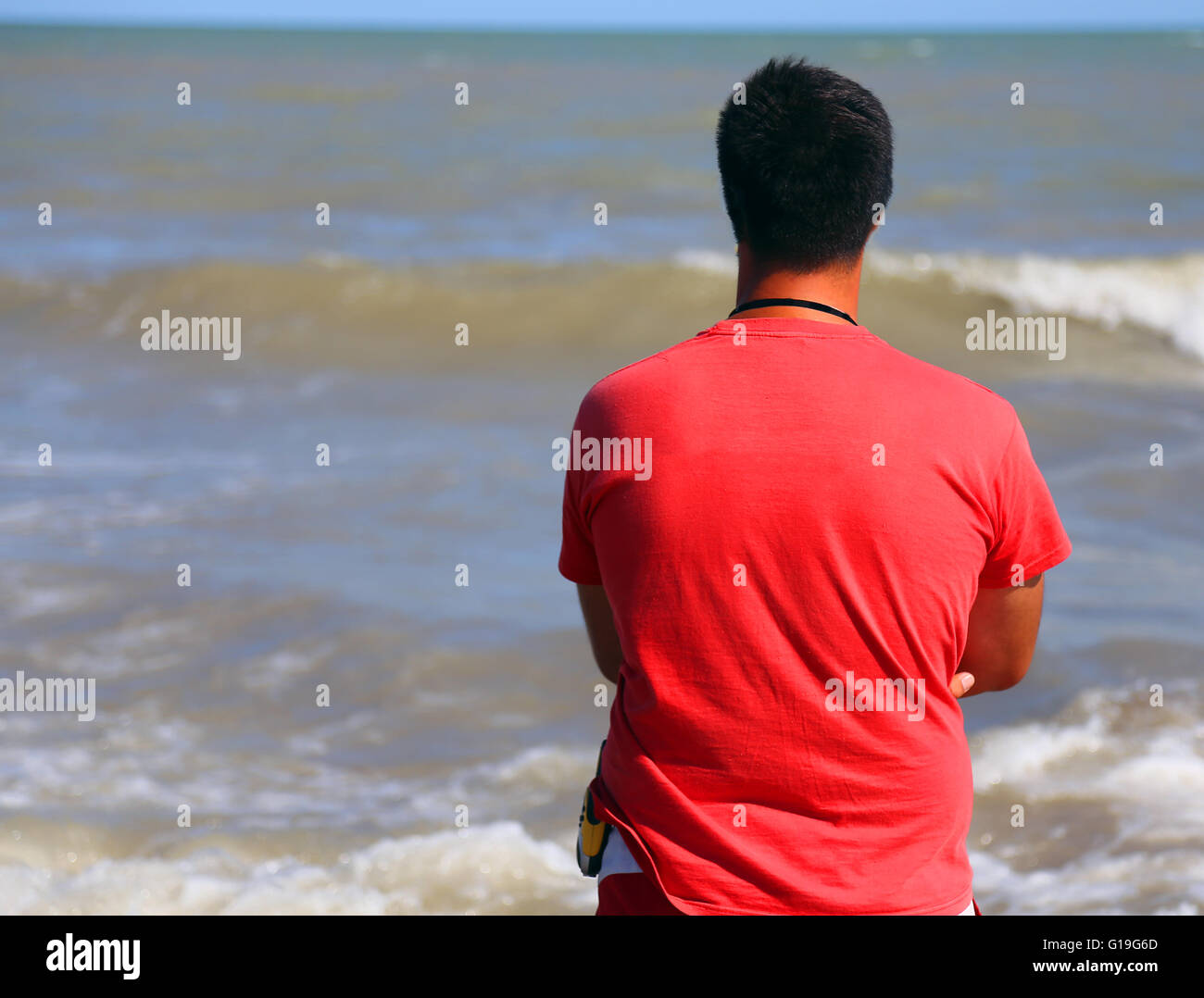 Lifeguard with red t-shirts when checking for swimmers in the sea in summer Stock Photo
