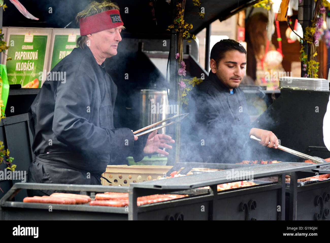 Prague, Czech Republic. Easter Market in Old Town Square, 2016. People cooking sausages outside Stock Photo