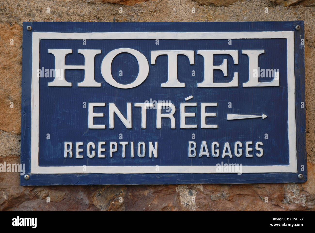 French sign at hotel entrance, with arrow pointing toward the reception. Ainhoa, Pyrénées-Atlantiques, France; Stock Photo